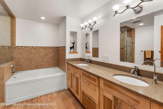 bathroom with vanity, separate shower and tub, and wood-type flooring