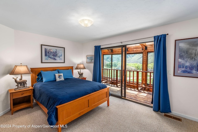 bedroom featuring carpet and access to exterior