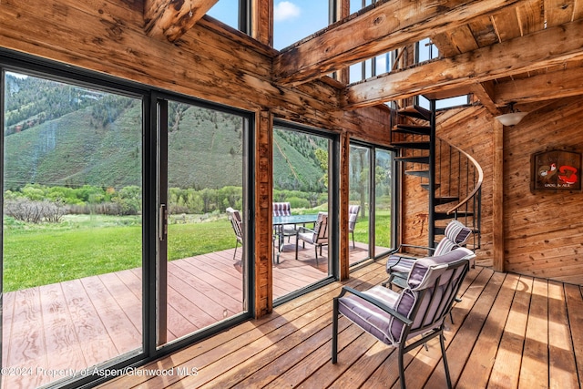 unfurnished sunroom with beamed ceiling