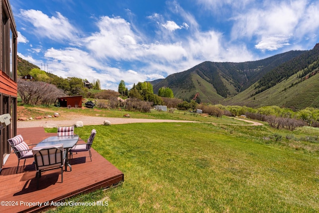 view of yard featuring a deck with mountain view