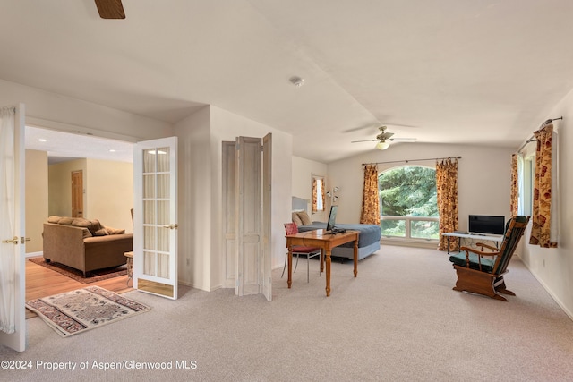 carpeted dining room featuring ceiling fan and lofted ceiling