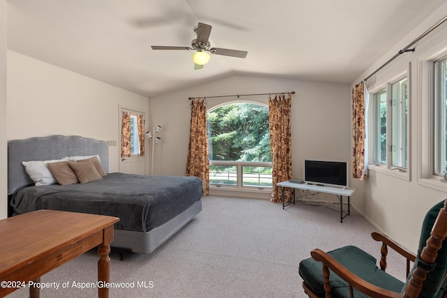 bedroom with carpet flooring, ceiling fan, lofted ceiling, and multiple windows