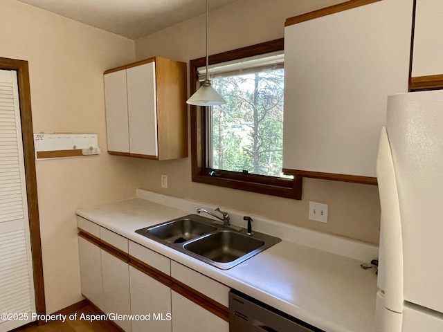 6616 High Dr, Morrison, CO 80465 - kitchen with freestanding refrigerator, white cabinets, light countertops, stainless steel dishwasher, and hanging light fixtures