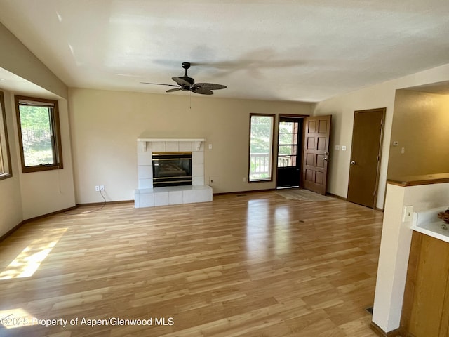 6616 High Dr, Morrison, CO 80465 - unfurnished living room with ceiling fan, a fireplace, and light wood-style flooring