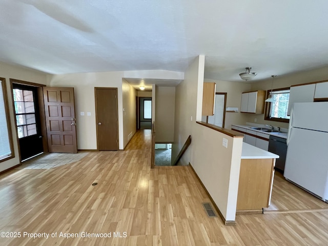 6616 High Dr, Morrison, CO 80465 - kitchen with freestanding refrigerator, dishwashing machine, light wood-style flooring, and a peninsula