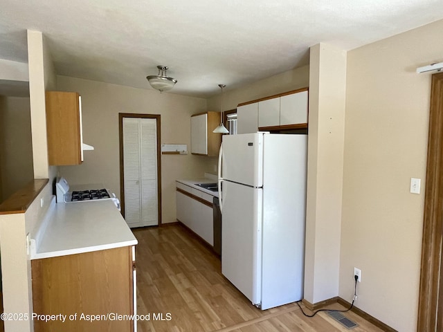 6616 High Dr, Morrison, CO 80465 - kitchen featuring white appliances, light wood-style flooring, light countertops, and white cabinetry