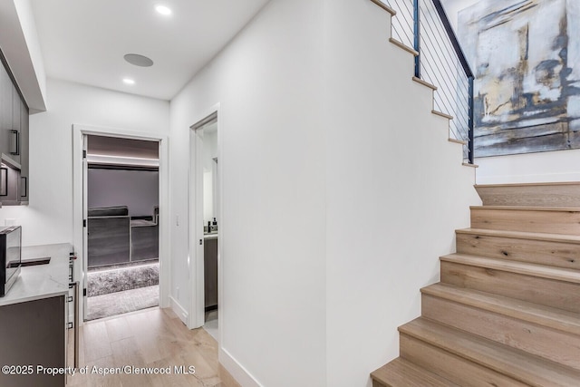 stairway with hardwood / wood-style floors