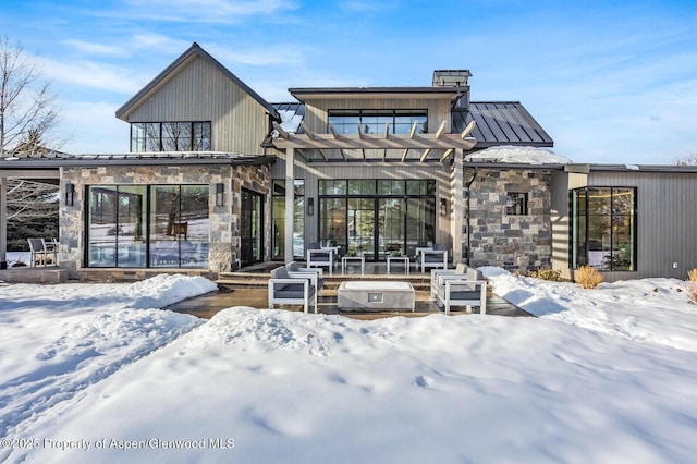 snow covered property featuring a pergola