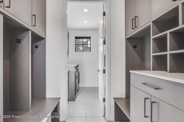 mudroom featuring separate washer and dryer and light tile patterned flooring