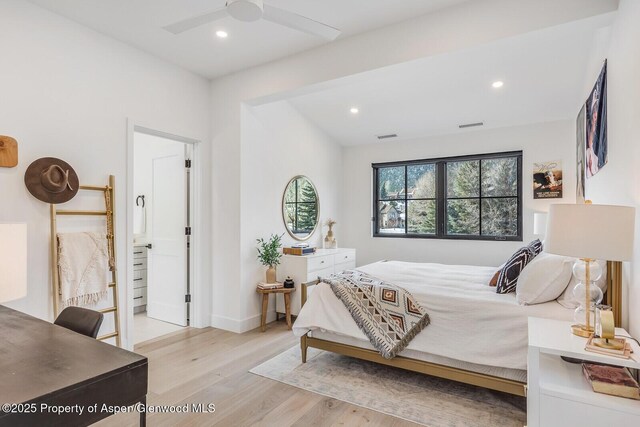 bedroom with ceiling fan, light hardwood / wood-style floors, and connected bathroom