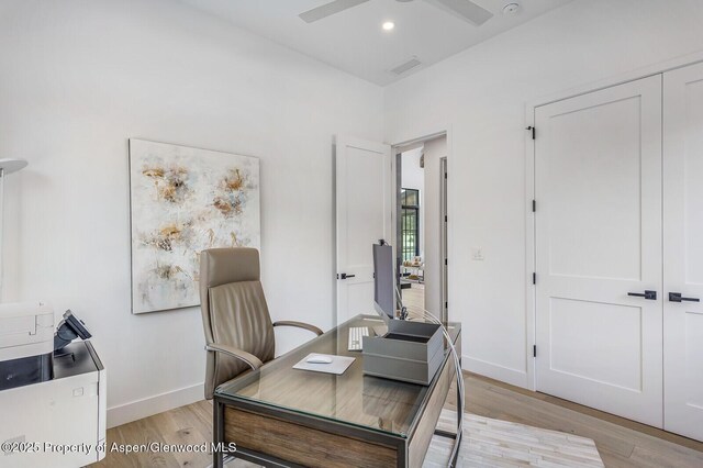 office with ceiling fan and light hardwood / wood-style floors