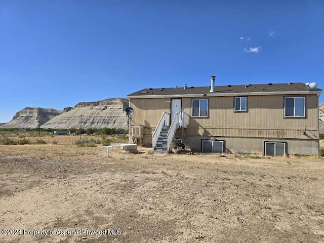 back of house featuring a mountain view