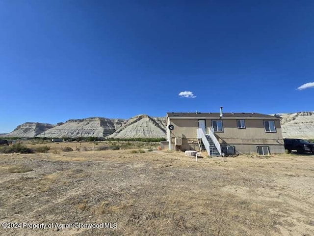 rear view of property featuring a mountain view