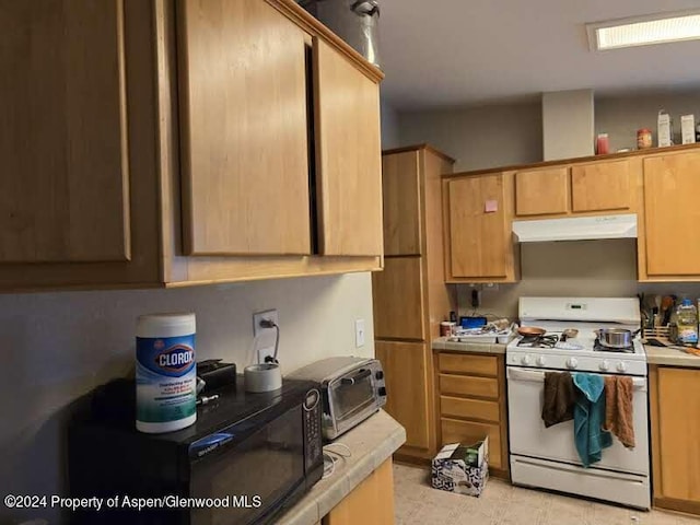 kitchen with white range with gas cooktop