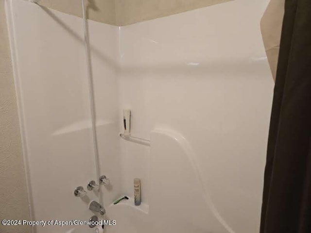 details featuring washtub / shower combination