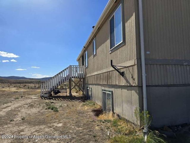 view of property exterior with a mountain view