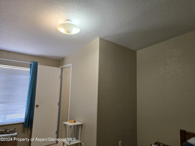 unfurnished bedroom with a textured ceiling