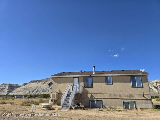 rear view of property featuring a mountain view