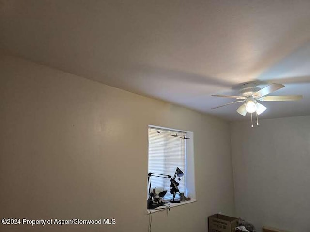 interior space with ceiling fan