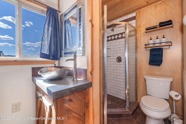 1210 County Road 103, Craig, CO 81625 - bathroom with vanity, a shower stall, toilet, and tile patterned floors