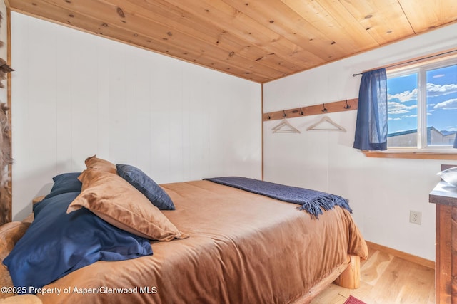 1210 County Road 103, Craig, CO 81625 - bedroom featuring wood finished floors, wooden ceiling, and baseboards