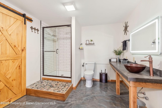 1210 County Road 103, Craig, CO 81625 - bathroom featuring finished concrete floors, a stall shower, a sink, toilet, and baseboards