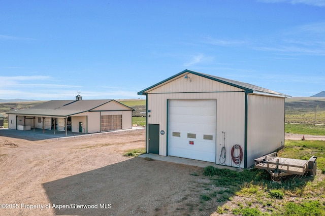 1210 County Road 103, Craig, CO 81625 - detached garage featuring a mountain view and dirt driveway