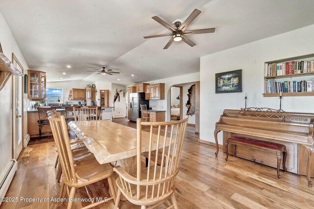 1210 County Road 103, Craig, CO 81625 - dining room with ceiling fan, a baseboard heating unit, lofted ceiling, light wood-type flooring, and arched walkways
