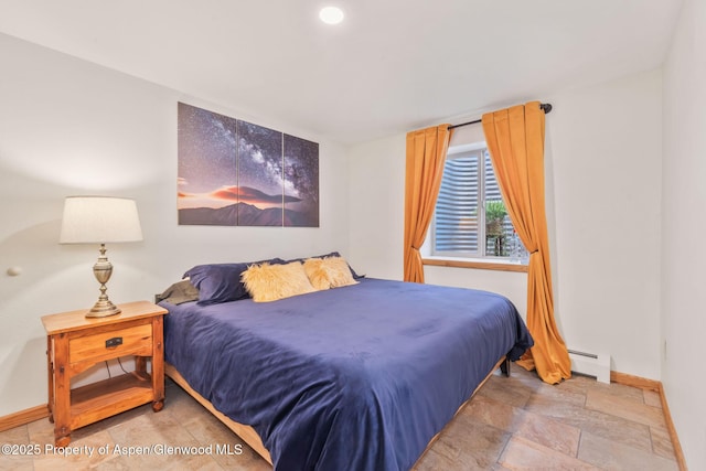 1210 County Road 103, Craig, CO 81625 - bedroom with baseboard heating, baseboards, and stone finish flooring