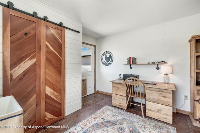 1210 County Road 103, Craig, CO 81625 - office area with a barn door, dark tile patterned flooring, and baseboards