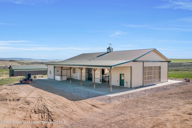 1210 County Road 103, Craig, CO 81625 - view of front facade featuring a garage, metal roof, and an outbuilding