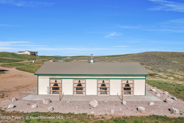 1210 County Road 103, Craig, CO 81625 - rear view of house with metal roof and a mountain view