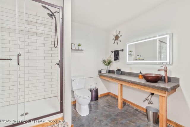 1210 County Road 103, Craig, CO 81625 - full bath with concrete flooring, a shower stall, a sink, and toilet