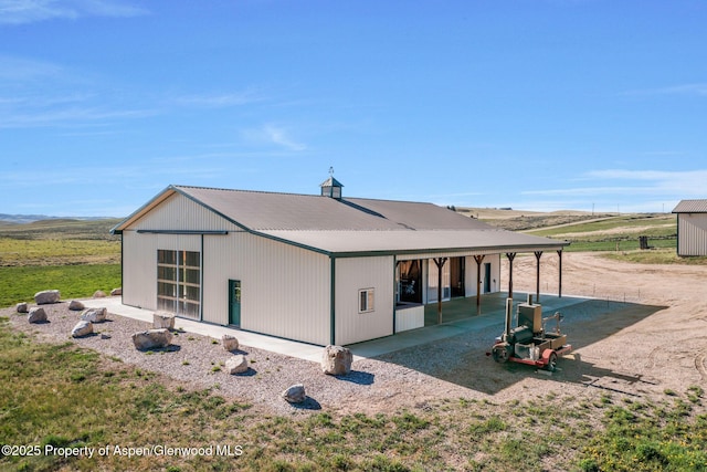 1210 County Road 103, Craig, CO 81625 - rear view of house featuring metal roof and an outdoor structure
