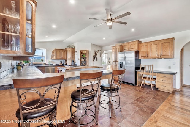 1210 County Road 103, Craig, CO 81625 - kitchen with arched walkways, stainless steel appliances, lofted ceiling, ceiling fan, and a peninsula
