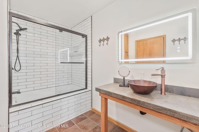1210 County Road 103, Craig, CO 81625 - bathroom featuring tiled shower / bath, tile patterned flooring, vanity, and baseboards