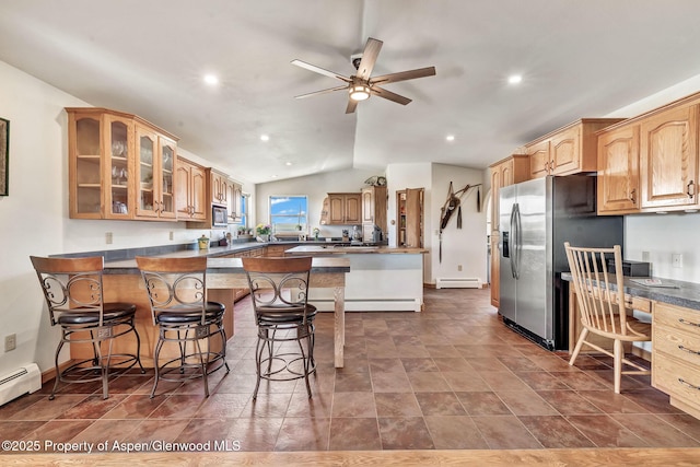 1210 County Road 103, Craig, CO 81625 - kitchen featuring a breakfast bar area, glass insert cabinets, dark countertops, a baseboard radiator, and appliances with stainless steel finishes
