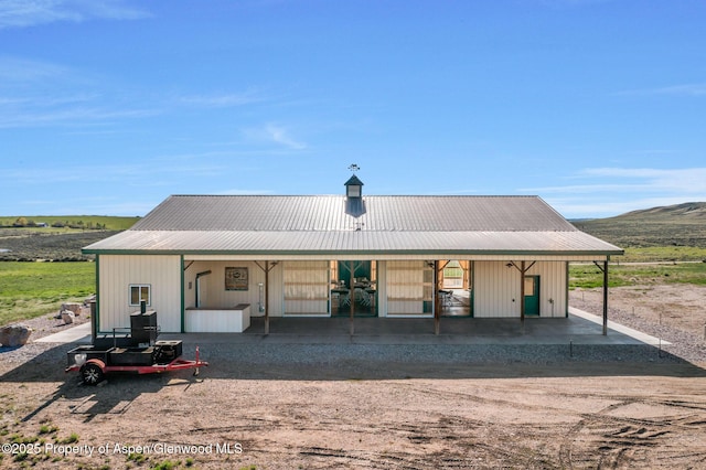 1210 County Road 103, Craig, CO 81625 - rear view of house with a porch and metal roof