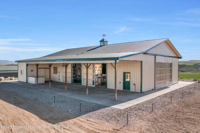 1210 County Road 103, Craig, CO 81625 - rear view of house with a garage and metal roof