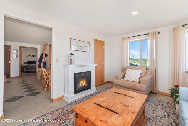 1210 County Road 103, Craig, CO 81625 - living room with baseboards, light tile patterned floors, a glass covered fireplace, and recessed lighting
