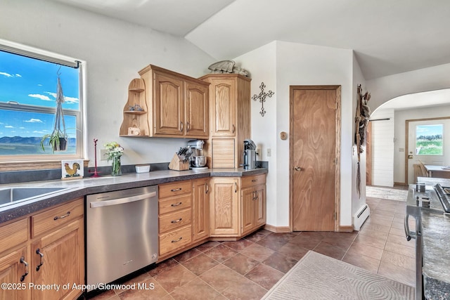 1210 County Road 103, Craig, CO 81625 - kitchen featuring stainless steel dishwasher, a baseboard radiator, arched walkways, dark countertops, and vaulted ceiling