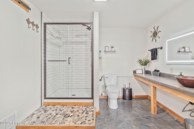 1210 County Road 103, Craig, CO 81625 - bathroom with a sink, toilet, a stall shower, concrete floors, and baseboards