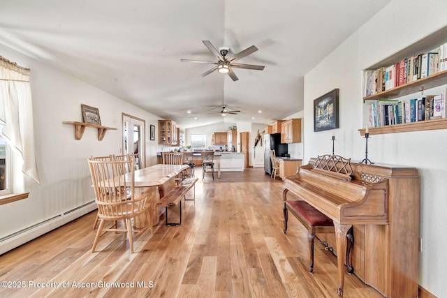 1210 County Road 103, Craig, CO 81625 - dining space with a baseboard radiator, vaulted ceiling, a ceiling fan, and light wood-style flooring