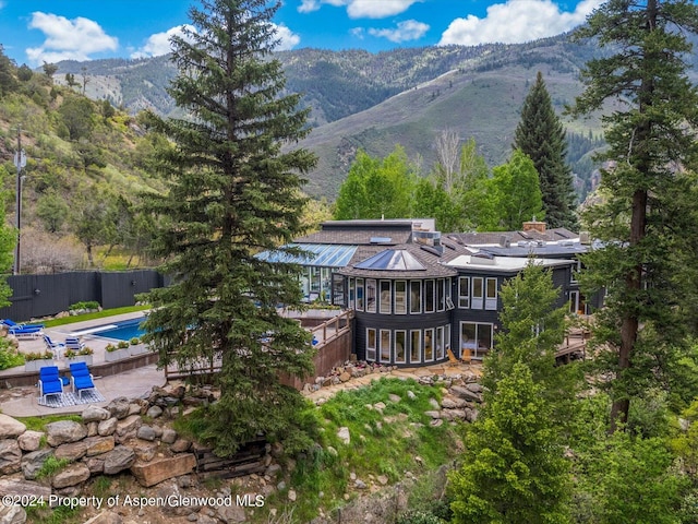 back of property with a mountain view