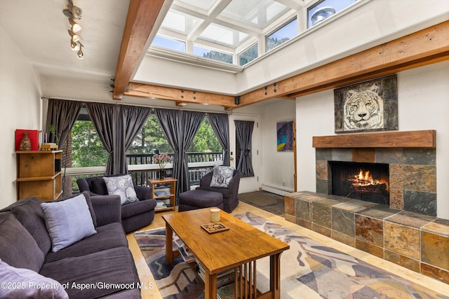 124 W Hyman Ave Unit 3B, Aspen, CO 81611 - living room featuring a fireplace, healthy amount of natural light, baseboard heating, track lighting, and beam ceiling