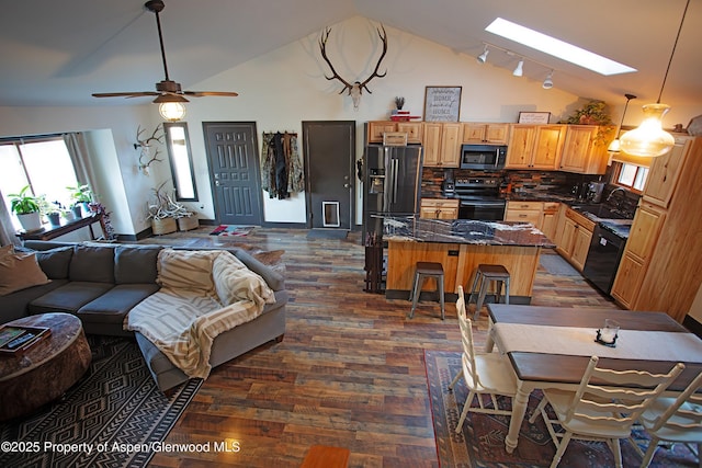212 Safflower Ct, New Castle, CO 81647 - kitchen with vaulted ceiling, open floor plan, dark wood-type flooring, a center island, and healthy amount of natural light