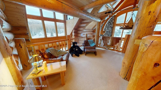 2418 Usfs Rd Unit 526, Creede, CO 81130 - living area featuring log walls, healthy amount of natural light, wood ceiling, and carpet floors