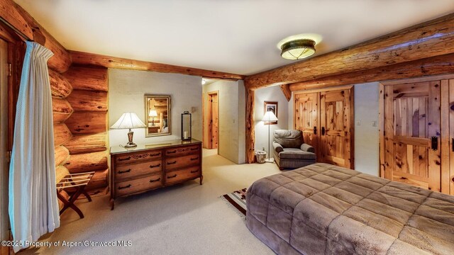 2418 Usfs Rd Unit 526, Creede, CO 81130 - bedroom with log walls and light colored carpet