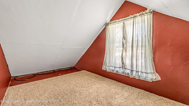 bonus room featuring vaulted ceiling