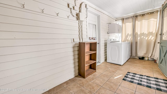 laundry room featuring light tile patterned floors, washer / clothes dryer, and wooden walls